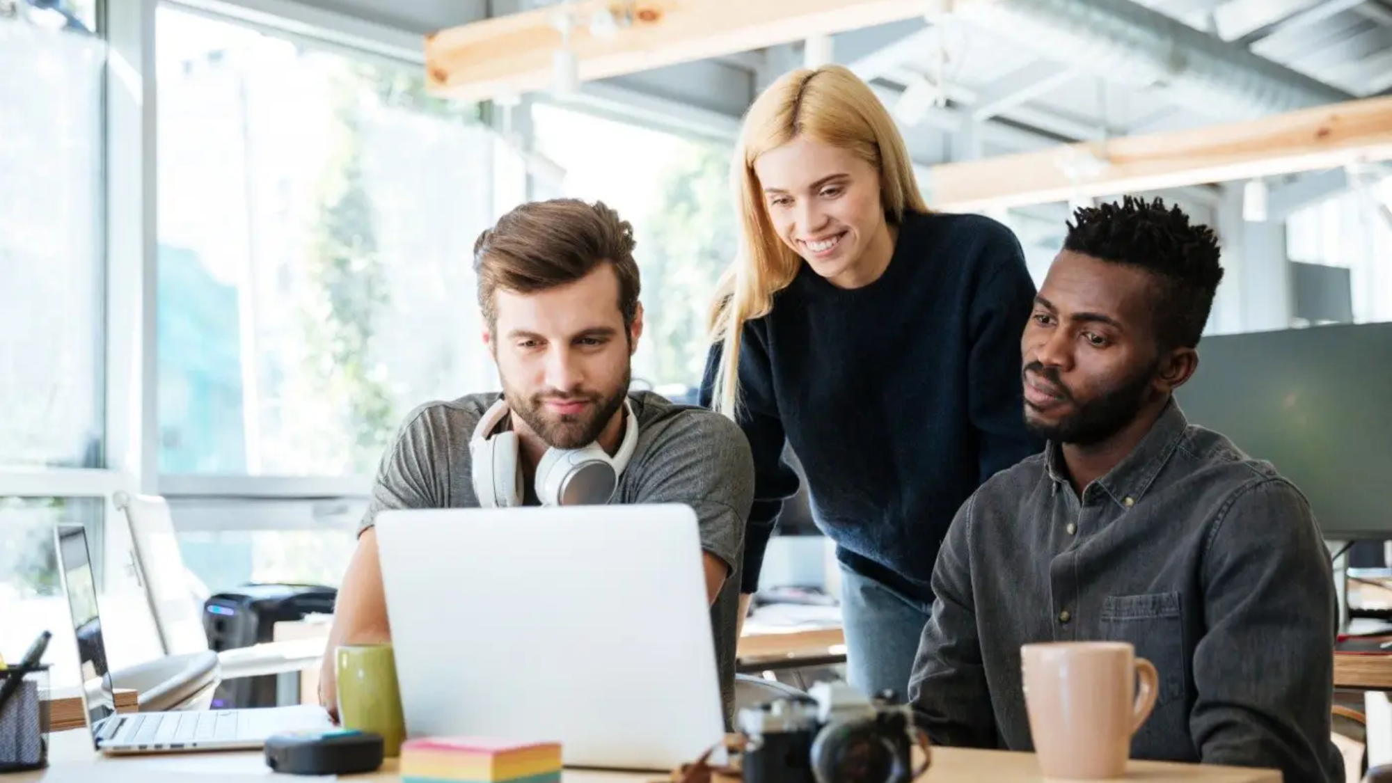 demo-attachment-2719-happy-colleagues-sitting-in-office-coworking-PHYA6TG
